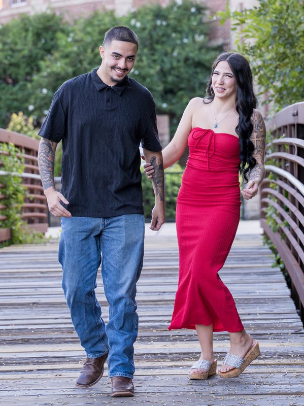 Couple walking together on a pedestrian bridge