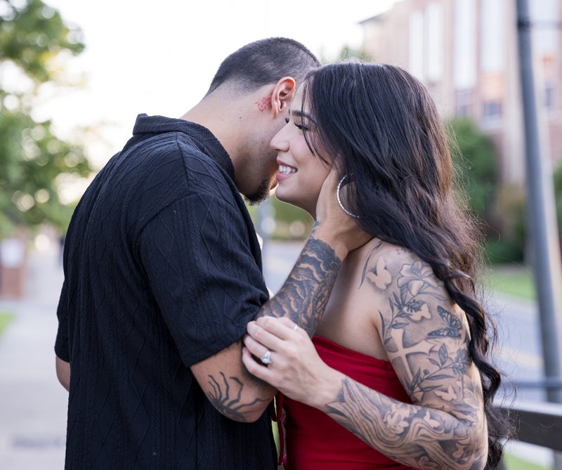 Woman smiling as her partner embraces her on the bridge