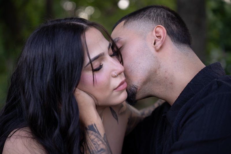 Close-up of a man kissing his partner on the cheek