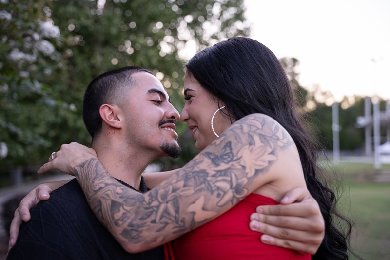 Couple smiling at each other during an embrace