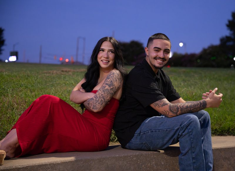 Couple sitting back to back on steps at blue hour