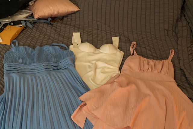 Wedding outfits arranged on a bed