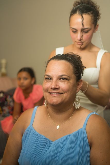 Bride helping a guest get ready