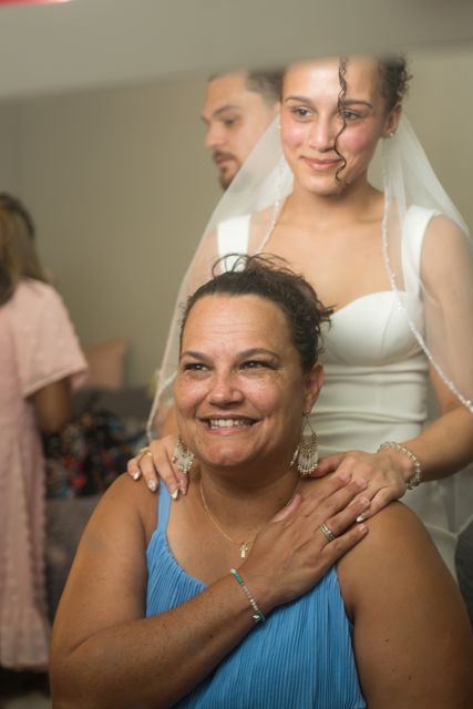 Bride helping a guest get ready