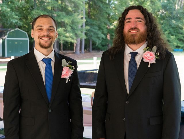 Groom posing with a guest