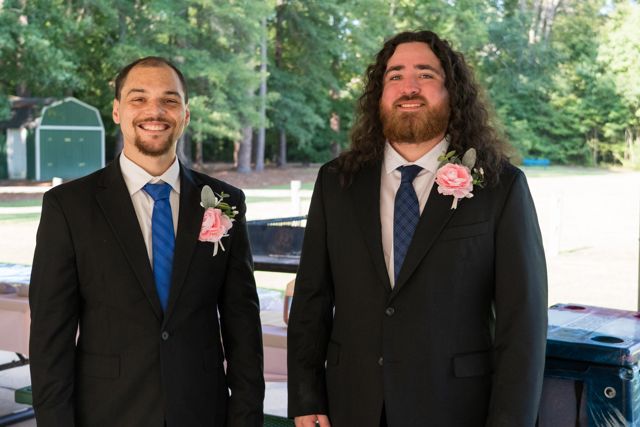 Groom posing with a guest