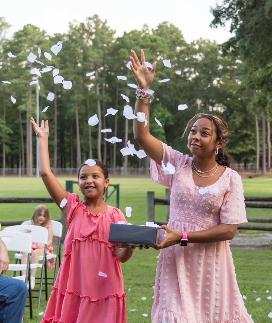 Young attendants scattering petals