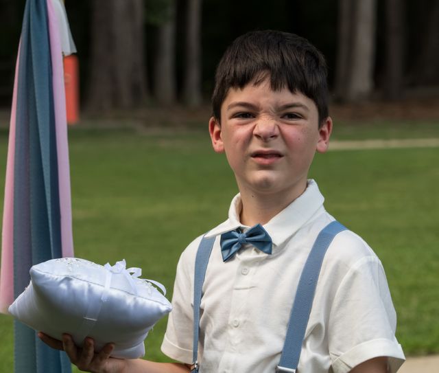 Young attendant holding a cushion