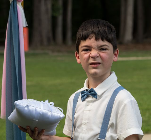 Young attendant holding a cushion
