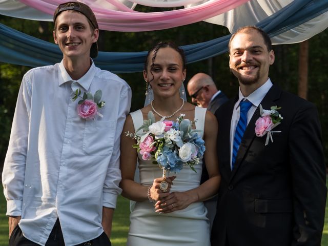 Newlyweds and guests posing together outdoors