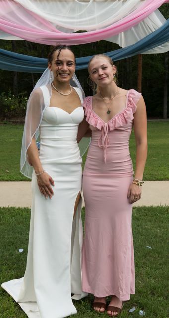 Bride and wedding guests posing outdoors