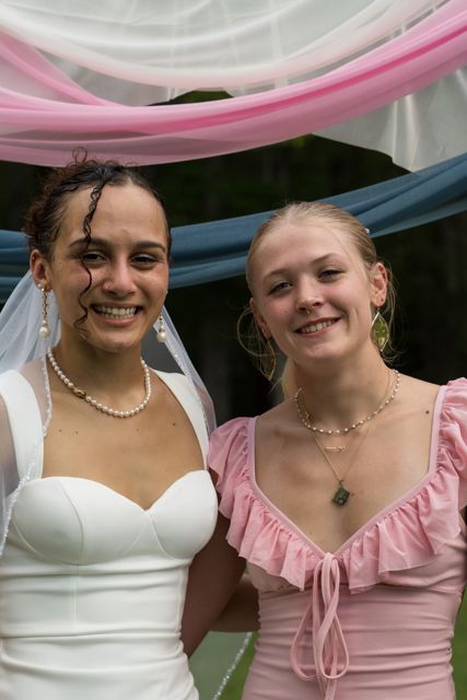 Bride and wedding guests posing outdoors