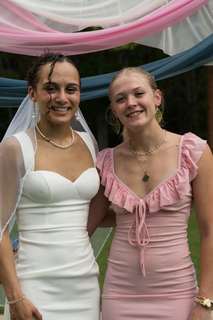 Bride and wedding guests posing outdoors