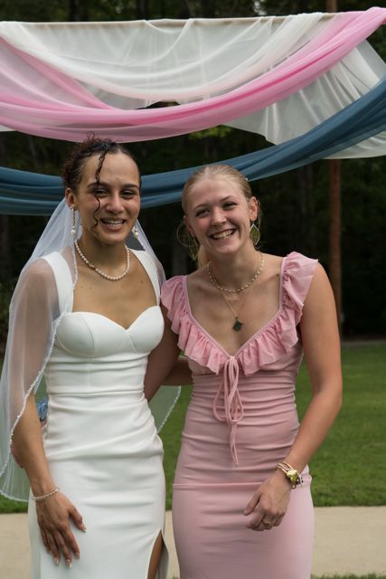 Bride and wedding guests posing outdoors
