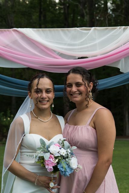 Bride and wedding guests posing outdoors