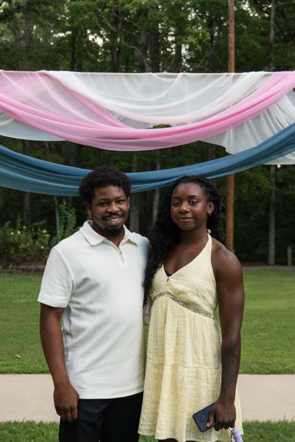 Bride and wedding guests posing outdoors