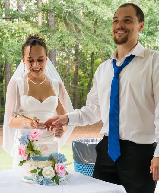 Newlyweds cutting their cake