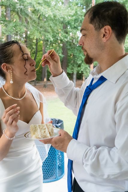 Newlyweds sharing wedding cake
