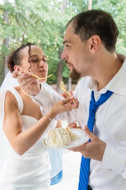 Newlyweds sharing wedding cake