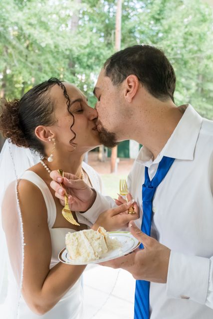 Newlyweds sharing wedding cake