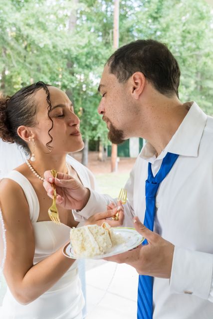 Newlyweds sharing wedding cake