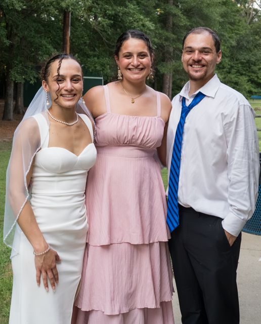 Newlyweds with a guest