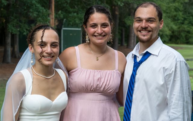 Newlyweds with a guest