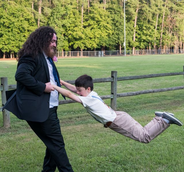 Playful wedding portrait on the lawn